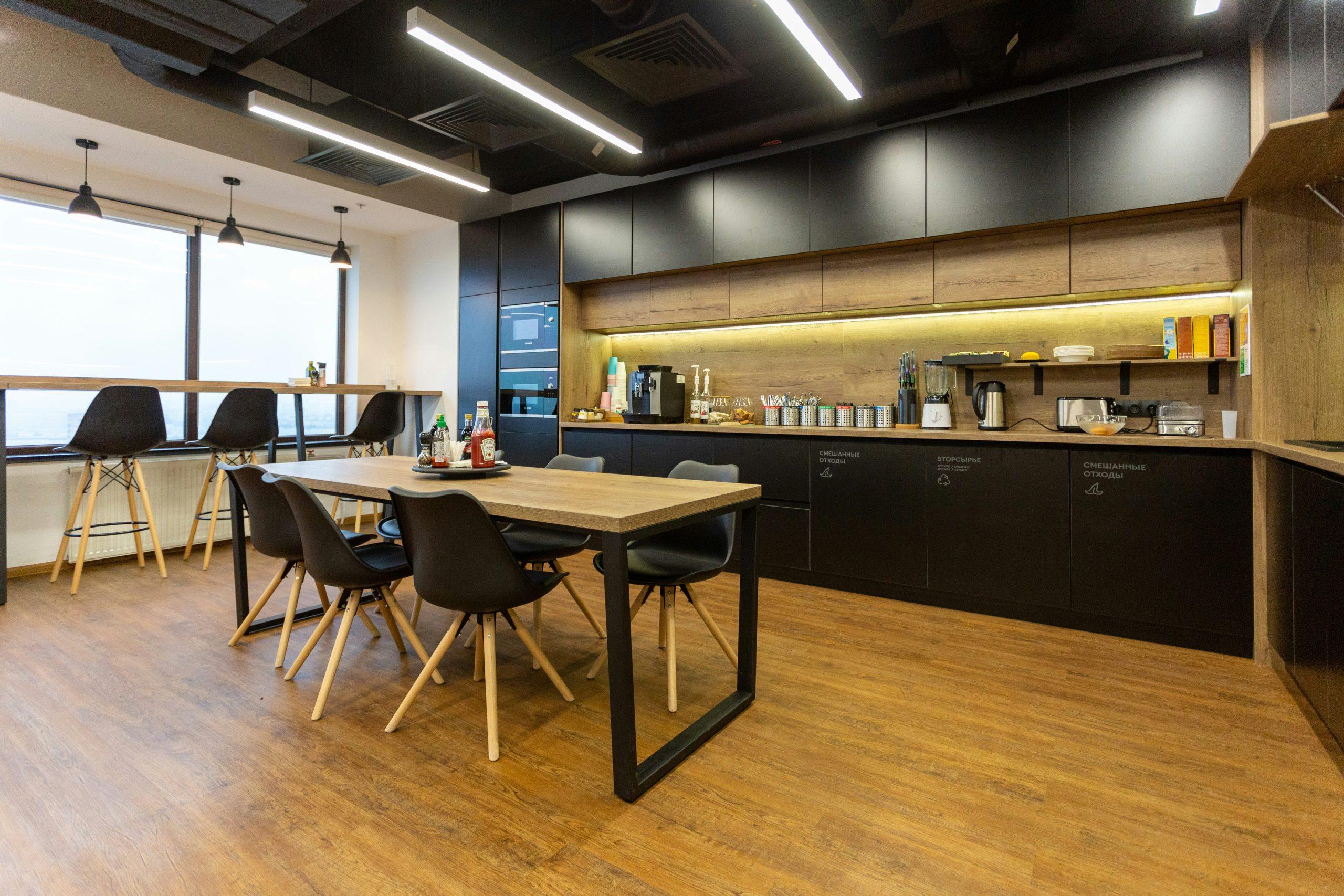 Modern office kitchen and staff breakout area with sink and cabinetry